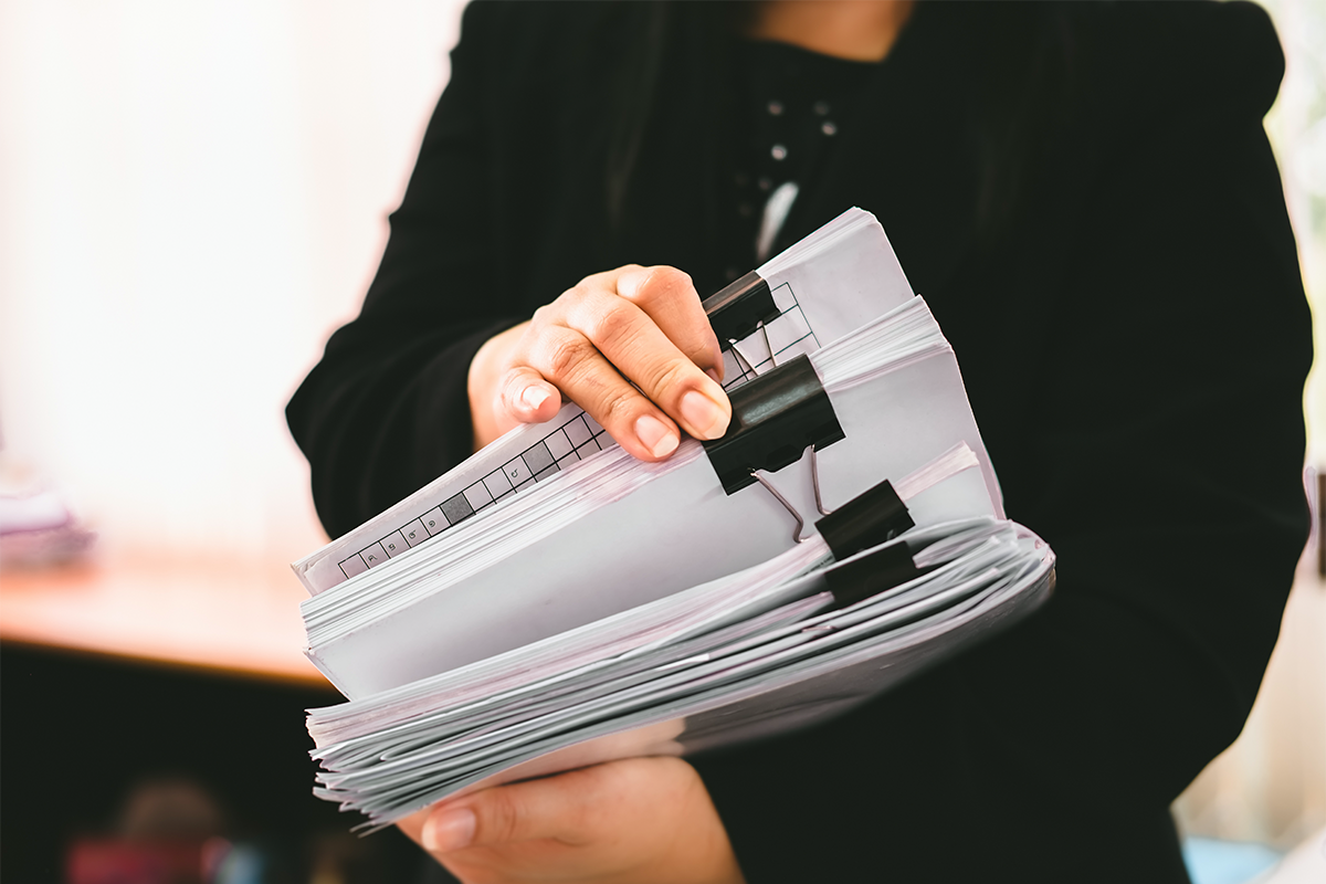 Woman shifting through stacks of documentation